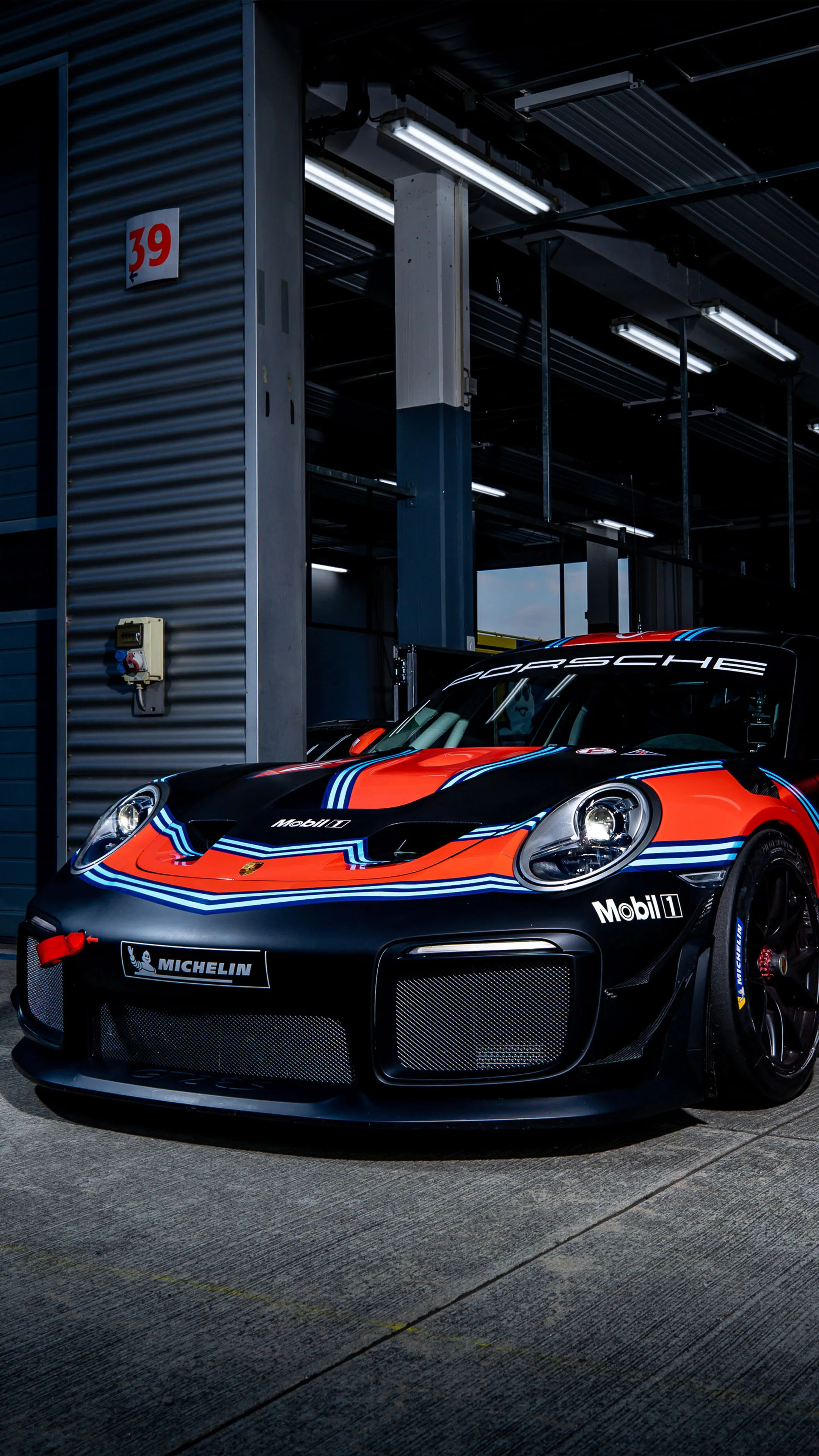 ATMOSPHERE — dark workshop, single car under light